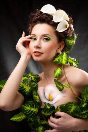 beautiful girl with body art and white flowers in hairの写真素材