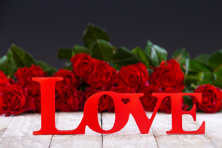 hearts and a bouquet of red roses on wooden board, Valentines Day backgroundの写真素材