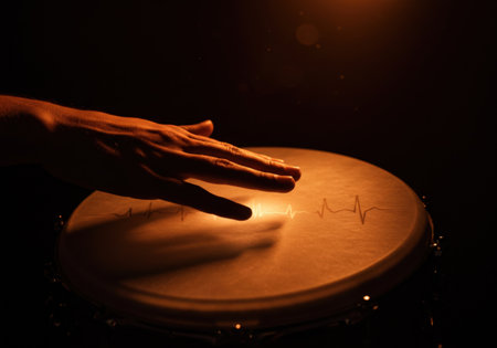 Hand touching drum surface with heart beat line illustrating the rhythm of music and life. Concept of World Music Day and passion for playing instrument.の素材