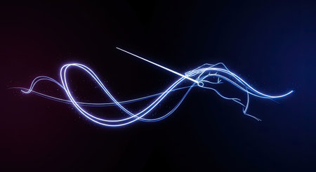 Hand of conductor with glowing baton creating music art on black background.の素材