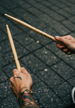 Man's hands playing drums on the street, performing a live gig for the celebration of World Music Day.の素材
