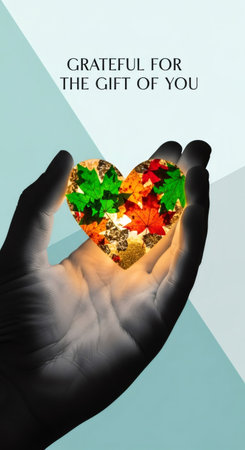 Hand holding a glowing heart full of autumn leaves. Thanksgiving gift concept for autumn holiday greeting card and gratitude message.の素材
