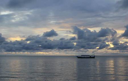 Boat in the sea at sunsetの写真素材