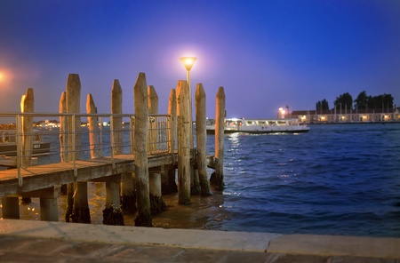 The wooden mooring in Venice with an evening lampの写真素材