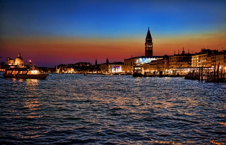 Evening Venice on fires with walking boats floating on waterの写真素材