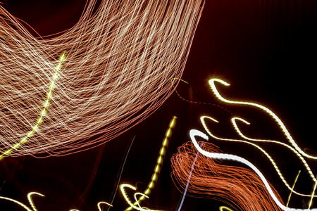 abstract lights made by firework and the lights in the street 