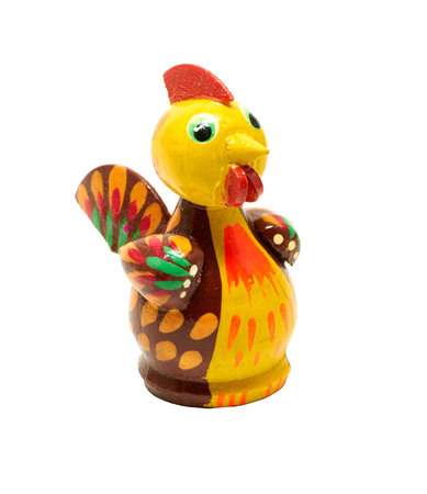 Colourful wooden figurine of rooster, chicken over whiteの写真素材