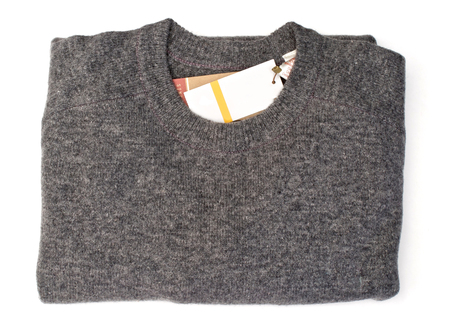 Isolated new folded grey sweater over whiteの写真素材