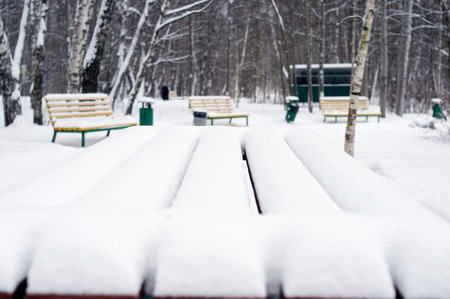 Table in snow outdoor in winter in Russia with benches on backgroundの写真素材