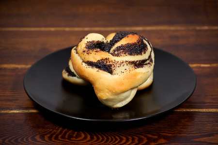Baked buns with poppy and sugar on the plate