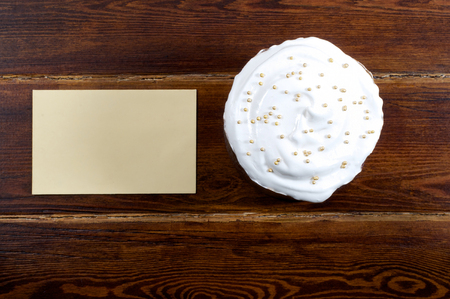 Easter cake with card over wooden background from topの写真素材