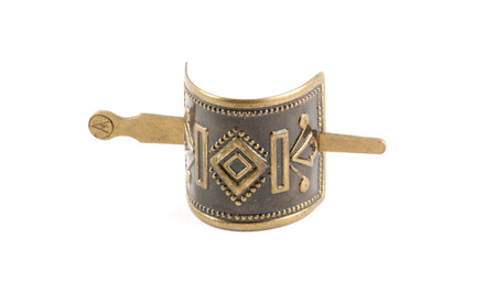 Isolated old bronze metallic barrette over whiteの写真素材