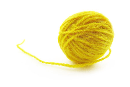 Yellow ball of knitting thread on a white backgroundの写真素材