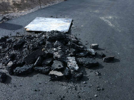 The remains of hot asphalt, just laid by the car and removed, smooth fresh asphalt