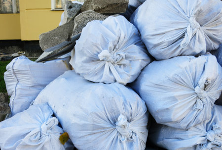 Garbage plastic bags with construction waste on the streetの写真素材
