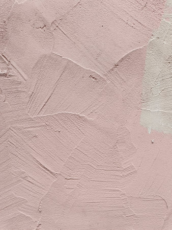 Pink plastered wall with traces of painting. Pink beautiful backgroundの写真素材
