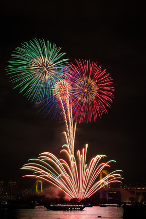 Firework festival over rainbow bridge at Odaiba bay, Tokyoの写真素材