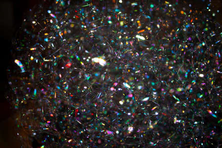 background photo of a cap of soap bubbles close-up in the dark, with glare of different colors of the rainbowの写真素材