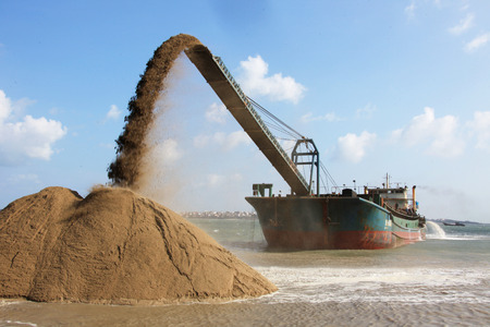 panning shore and the beach to build a new commercial sea container terminal.のeditorial素材