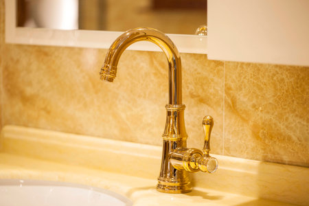 Closeup of water-supply faucet isolated in modern bathroomの写真素材
