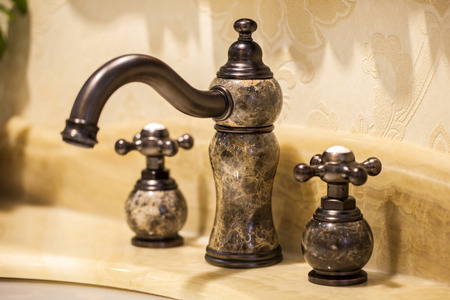 Closeup of water-supply faucet isolated in modern bathroomの写真素材