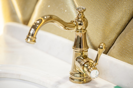 Closeup of water-supply faucet isolated in modern bathroomの写真素材