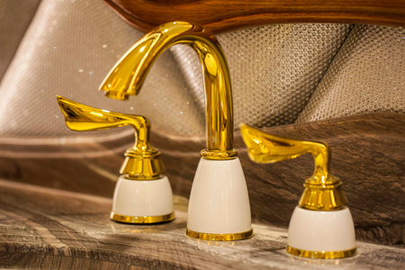 Closeup of water-supply faucet isolated in modern bathroomの写真素材