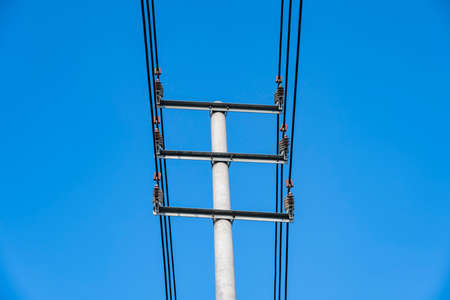 power pole under a blue sky. electric poles.の写真素材