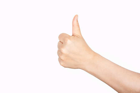 Closeup of female hand showing thumbs up sign against white background.