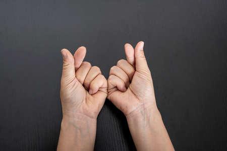 Closeup of female hand showing love sign. Love gesture conceptの写真素材