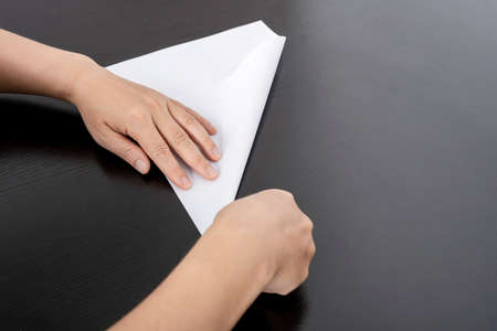 A woman is folding paper.