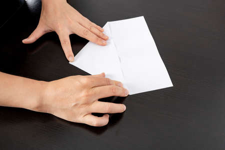 A woman is folding paper.の写真素材