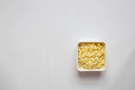 Chopped garlic in white plate on white background. top view.の写真素材
