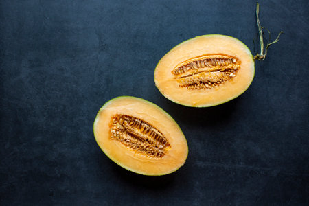 Fresh Juicy honeydew melon sliced on dark gray background .healthy food.hami melon.の写真素材
