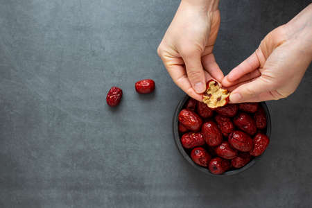 Dried Jujube, Chinese dried red date fruit on dark grey background.の写真素材