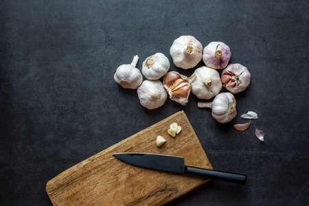 Garlic and Garlic Cloves and sliced garlic on dark grey background.の写真素材