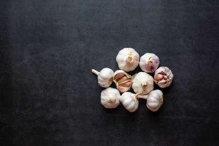 Garlic and Garlic Cloves and sliced garlic on dark grey background.の写真素材
