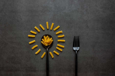 Spiral macaroni on dark grey background.の写真素材