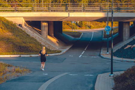 bicycle and pedestrian paths under the bridge with a running man.