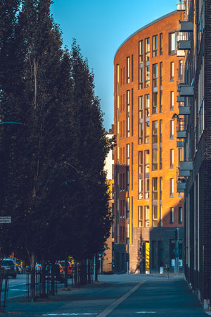 A sturdy brick building prominently displays a sign on its facade, making it a notable part of the urban landscapeの写真素材