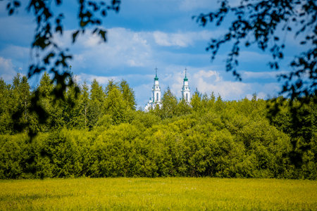There is a white church building with two towers, creating a striking sightの写真素材