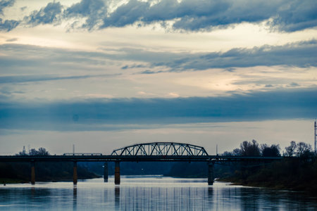 city bridge over the river under a cloudy sky nice photoの写真素材