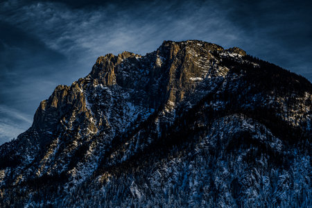 Majestic mountains under a serene blanket of snow, capturing the breath-taking beauty of winter's...