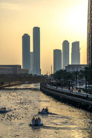 A stunning city skyline featuring a prominent large body of water in the foreground that beautifully reflects the surrounding urban landscapeの写真素材