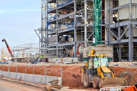 Construction Site Featuring Heavy Machinery and Visible Steel Framework and Structuresの写真素材