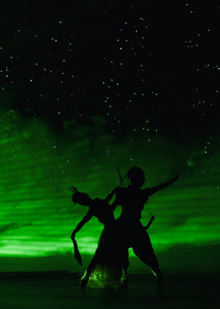 Individuals are dancing in front of a vibrant green backgroundの写真素材