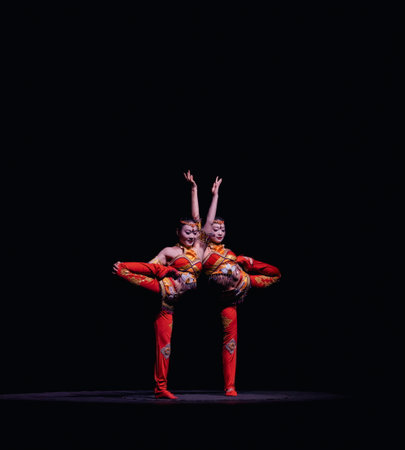 A Graceful Duo Performing a Traditional Art with Elaborate and Colorful Costumes