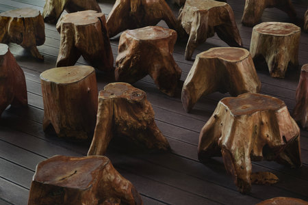 Unique wooden stools are artistically arranged in a modern interior, showing natural beauty and thoughtful designの写真素材