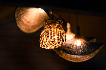 Stylishly elegant woven lamp shades elegantly illuminating a cozy space, creating an inviting warm light ambianceの写真素材