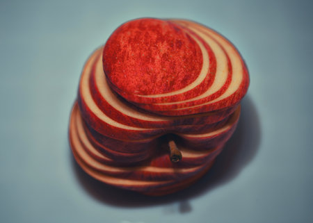 Closeup of apple with paprika emphasizing contrasting texturesの写真素材